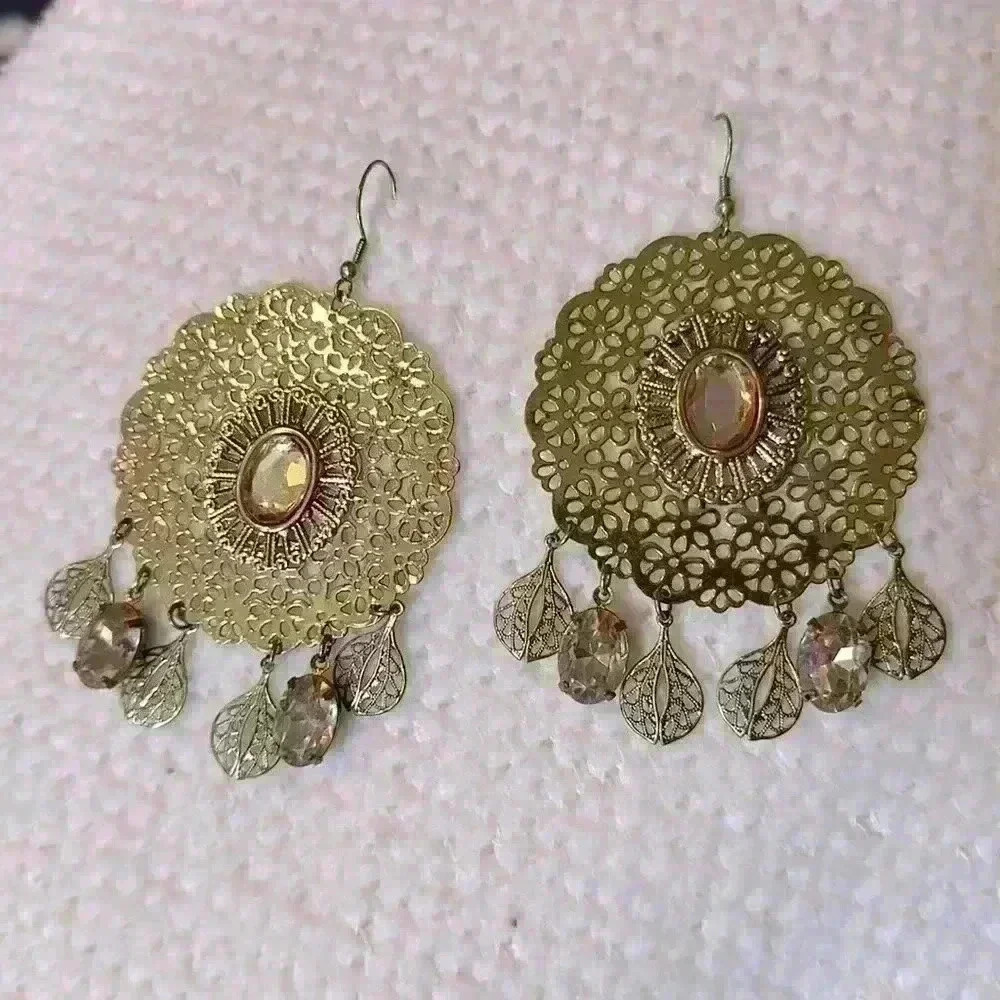 Hanging gold colored earrings
